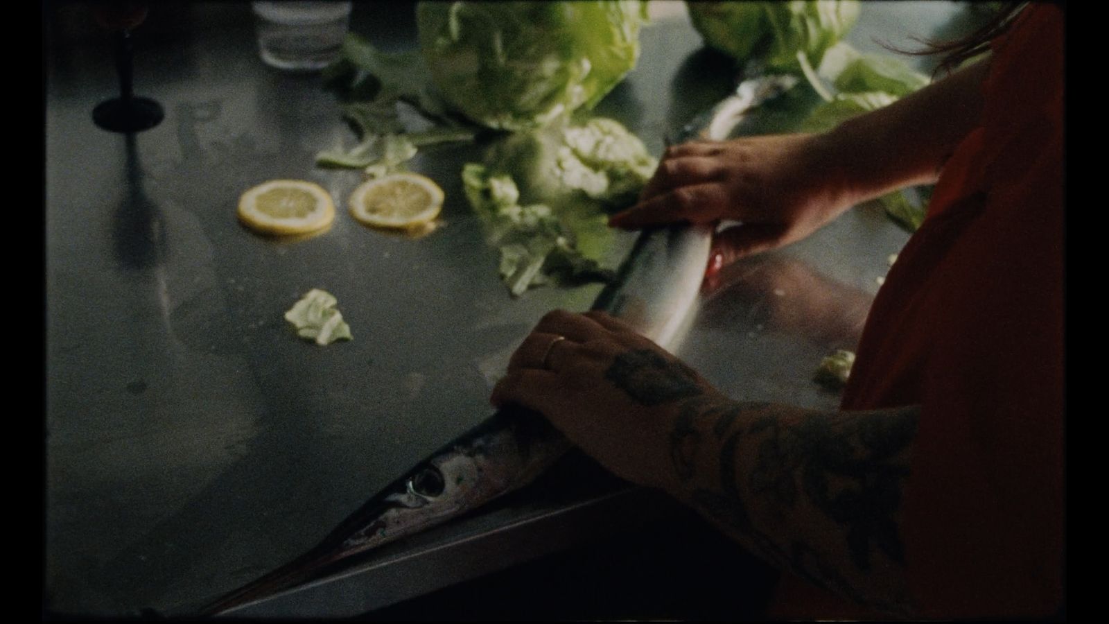 a person cutting up some food on a cutting board