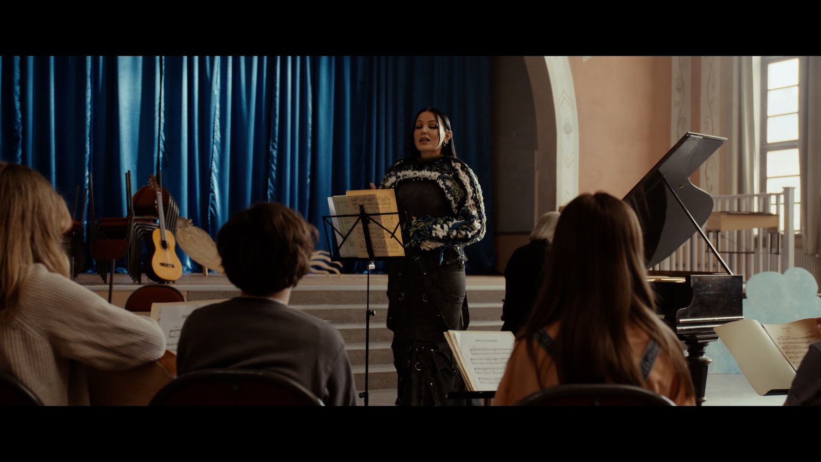 a woman standing in front of a group of people