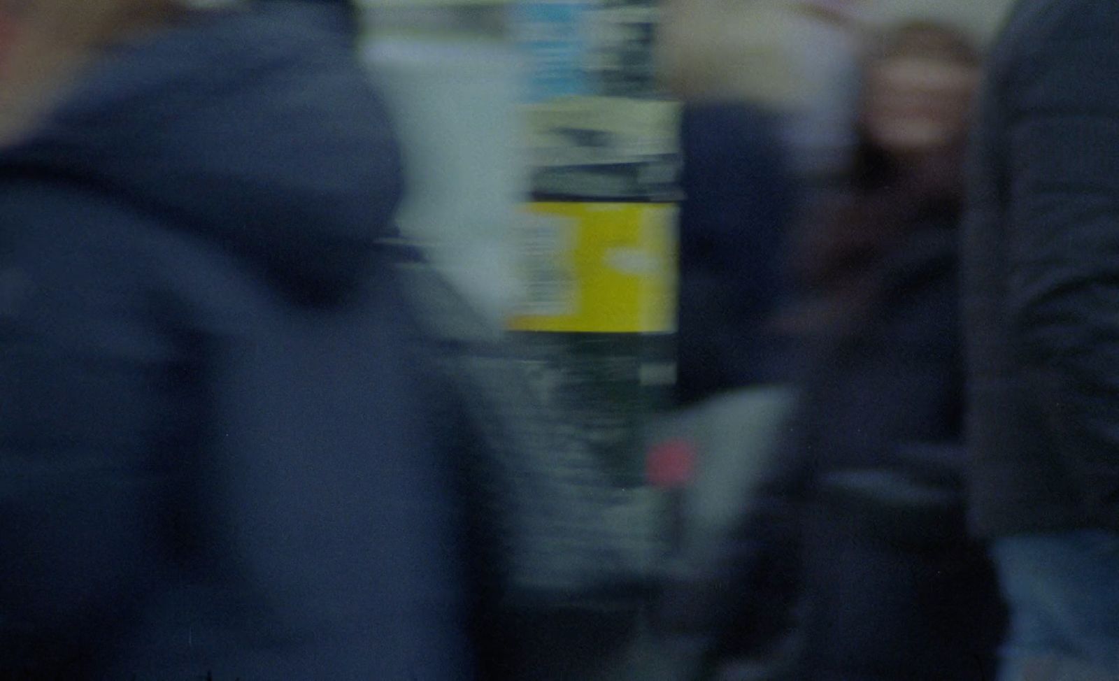 a blurry photo of people walking down a street