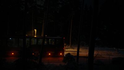 a bus driving down a road at night