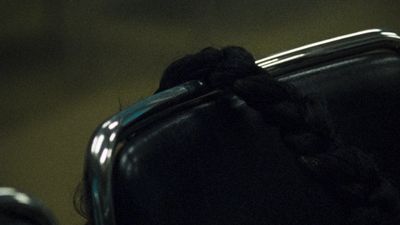 a close up of a black chair with a rope on it