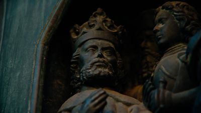 a close up of a statue of a man with a crown