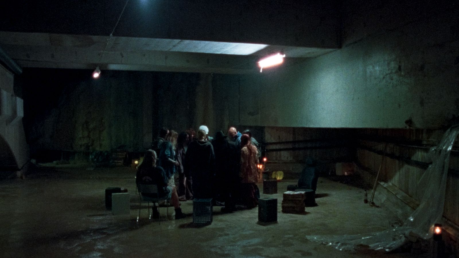 a group of people standing in a dark room