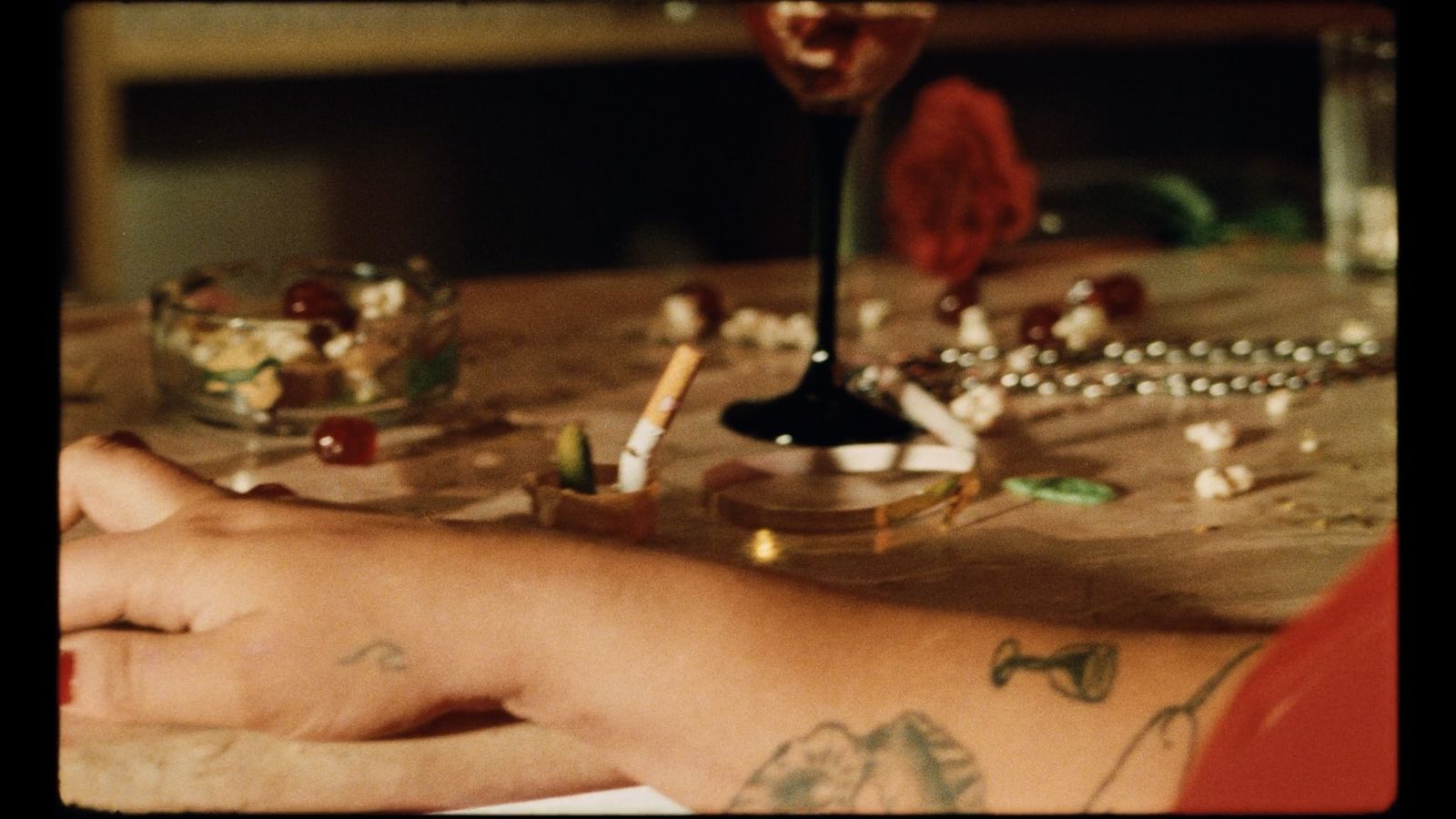 a person with a tattoo on their arm sitting at a table