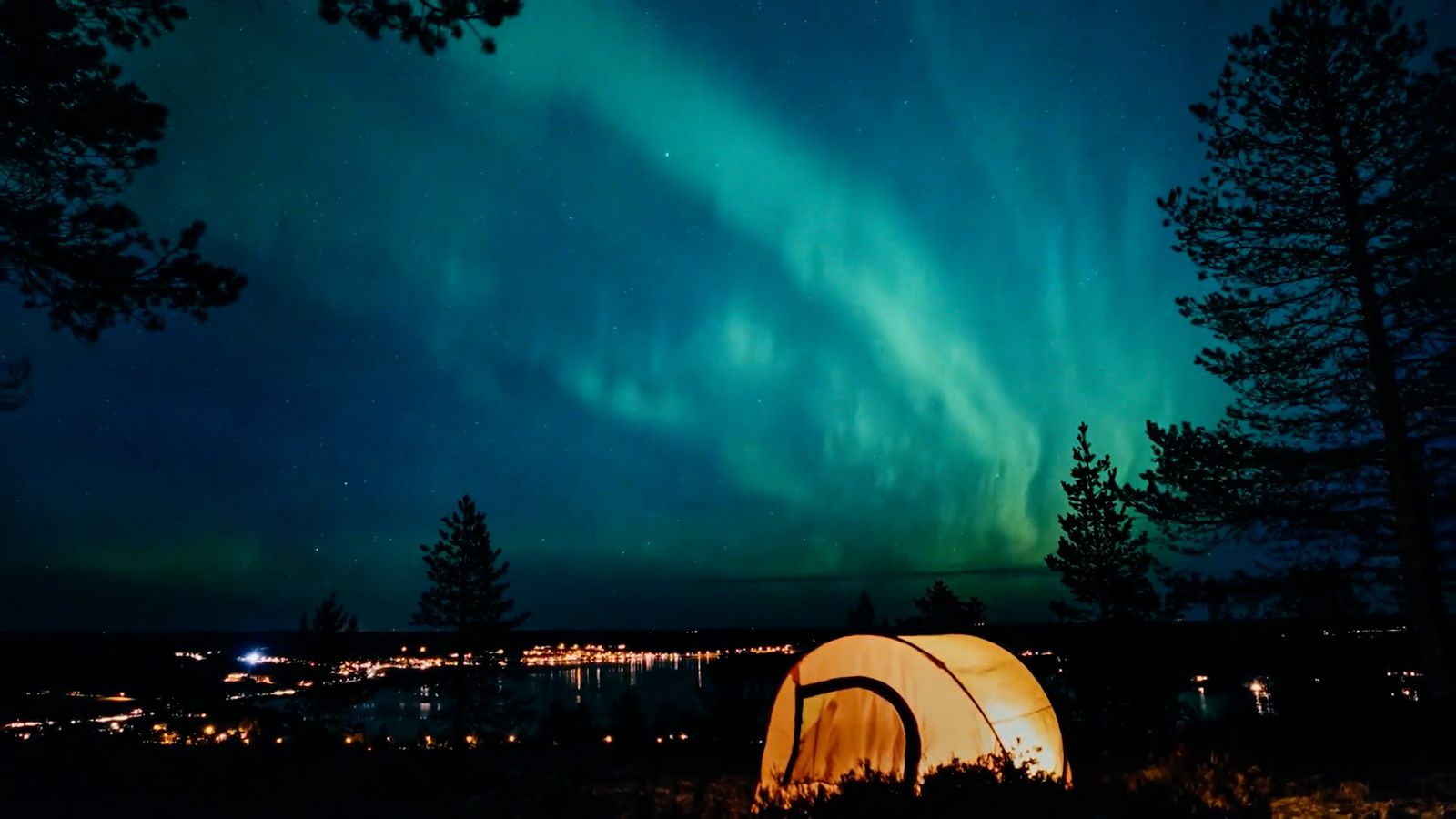 a tent in the woods under a green and blue sky