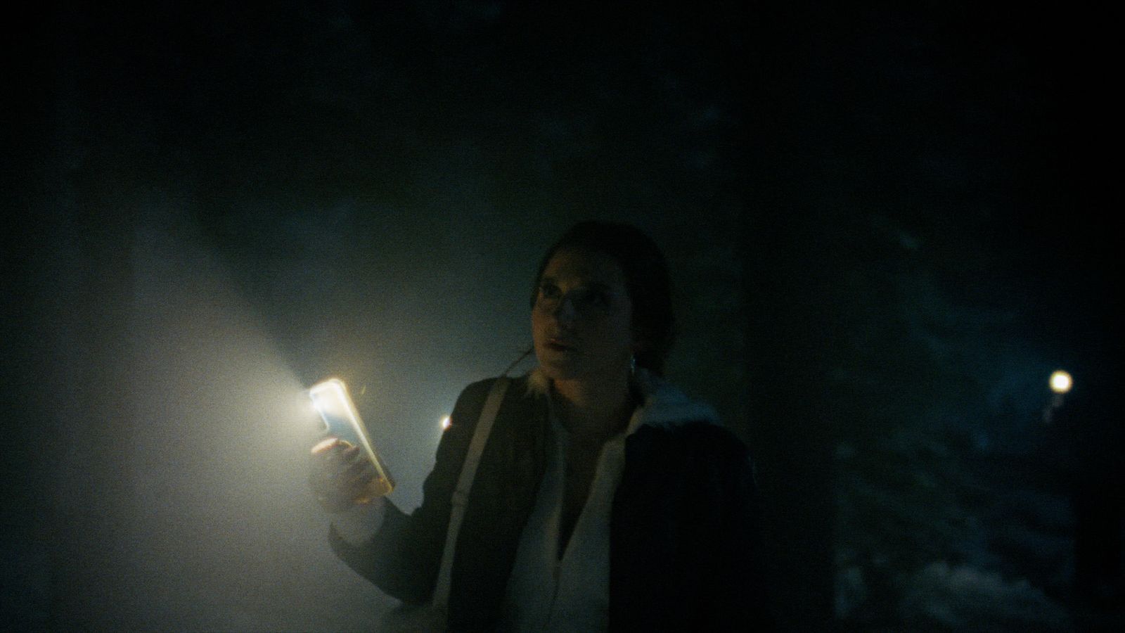 a woman holding a light in her hand