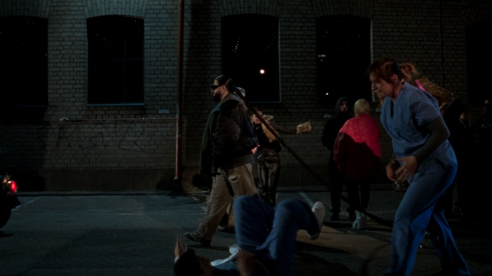 a group of people standing in a parking lot