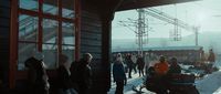 a group of people standing next to a ski lift