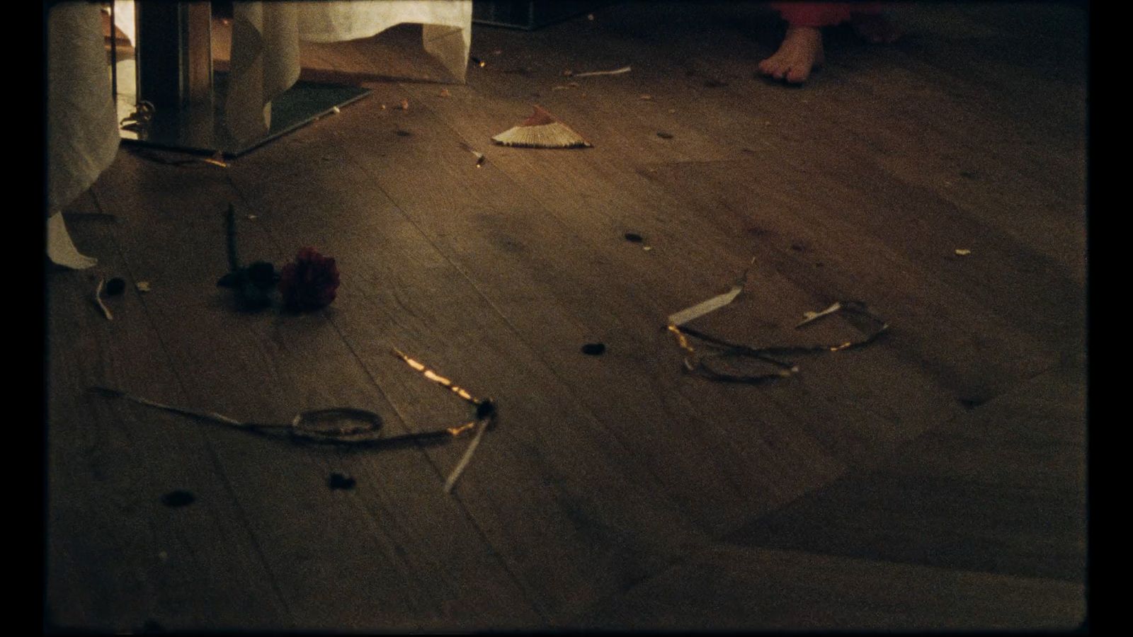 a room with a wooden floor and a bunch of debris on the floor