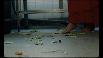 a person in a red dress standing on a floor