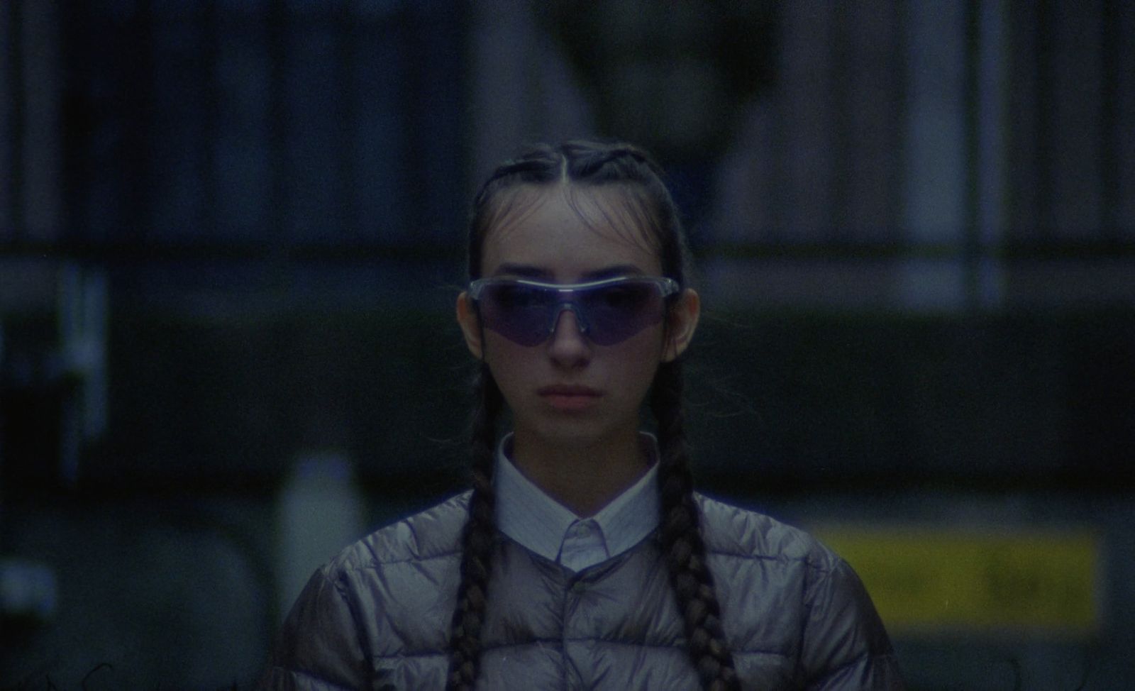 a woman with long braids wearing sunglasses