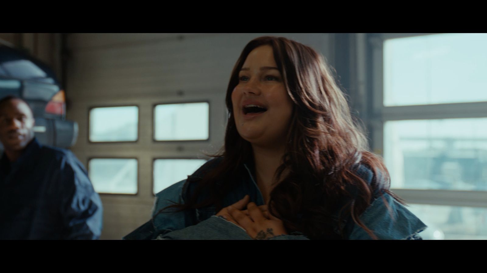 a woman standing next to a man in a garage