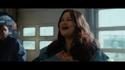 a woman standing next to a man in a garage