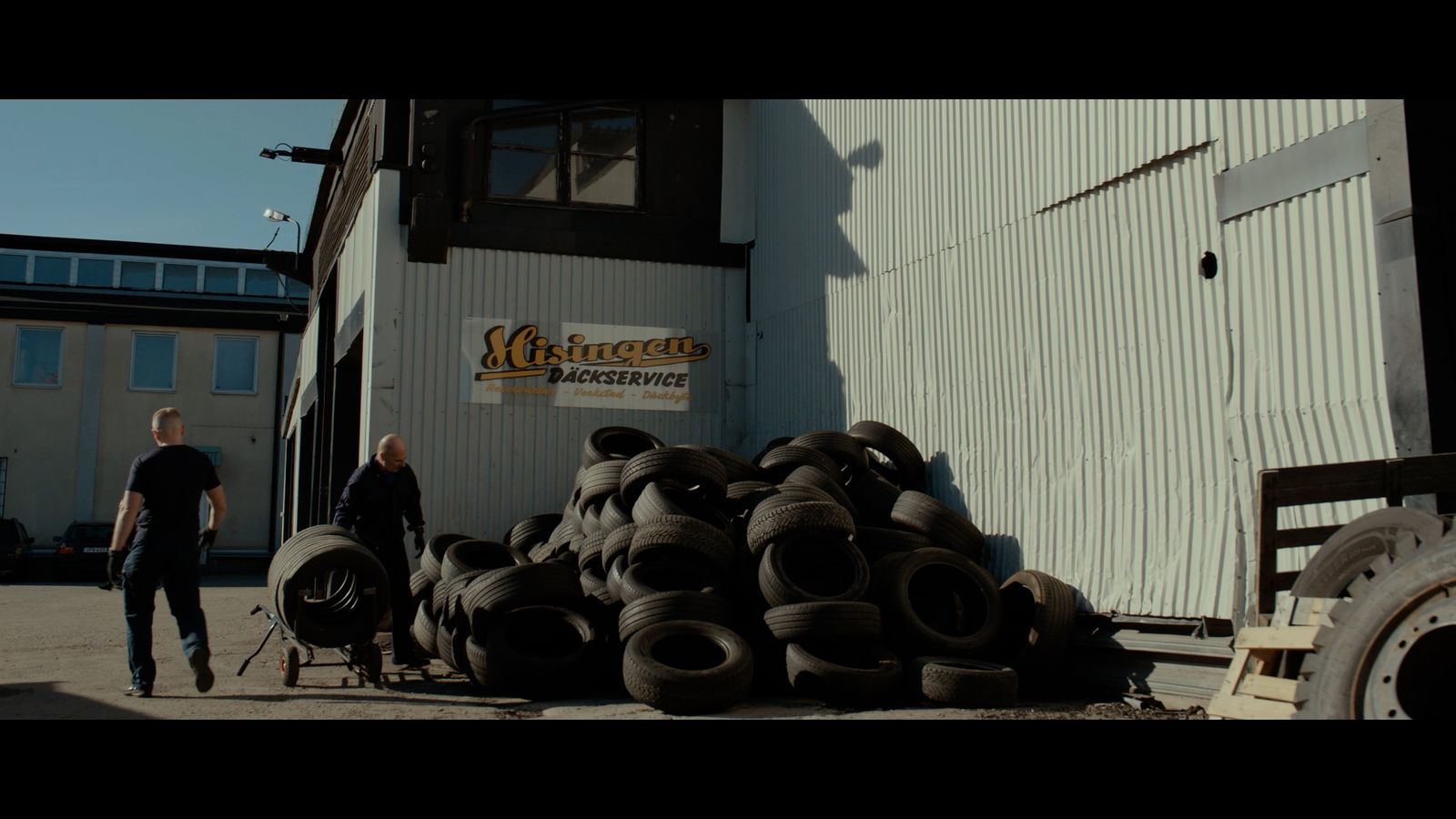 a pile of tires sitting outside of a building