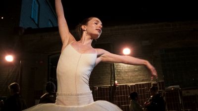 a woman in a white dress is dancing