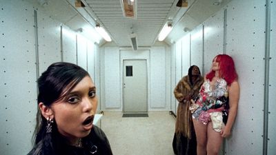 a group of women standing in a hallway next to each other