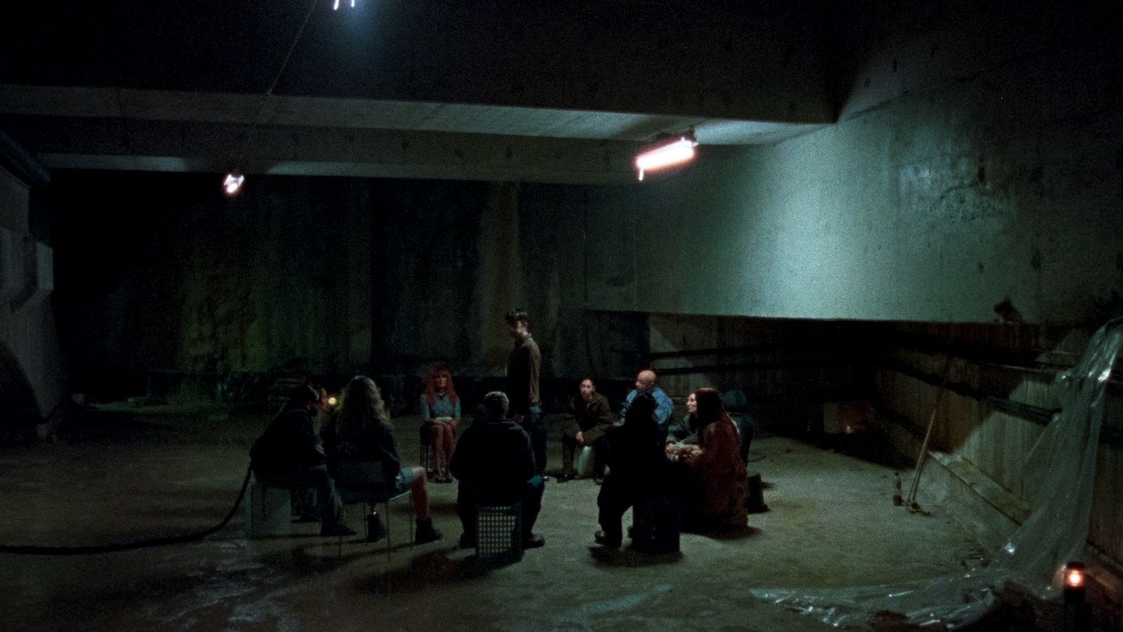 a group of people standing around in a dark room