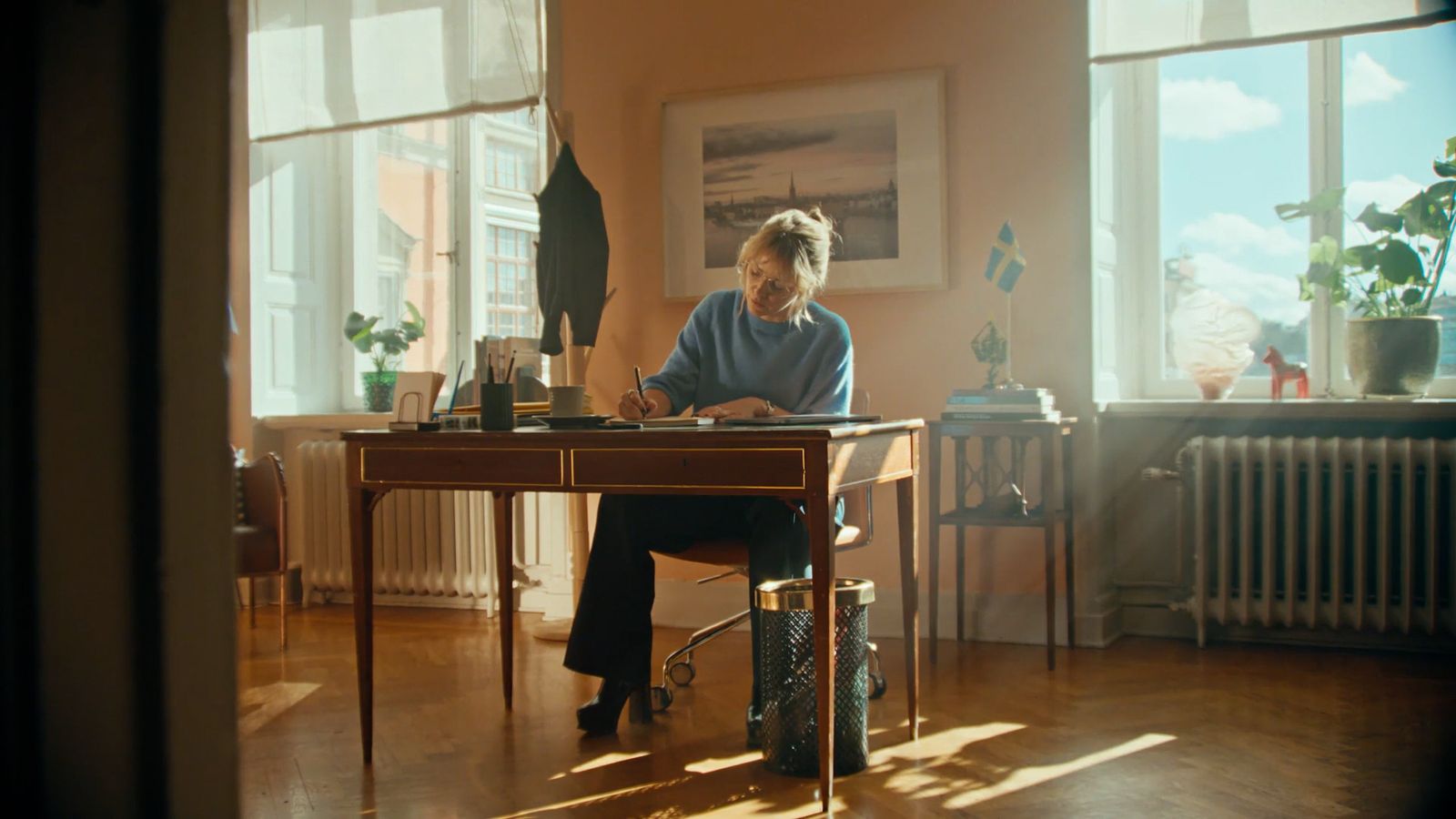 a man sitting at a desk in front of a window