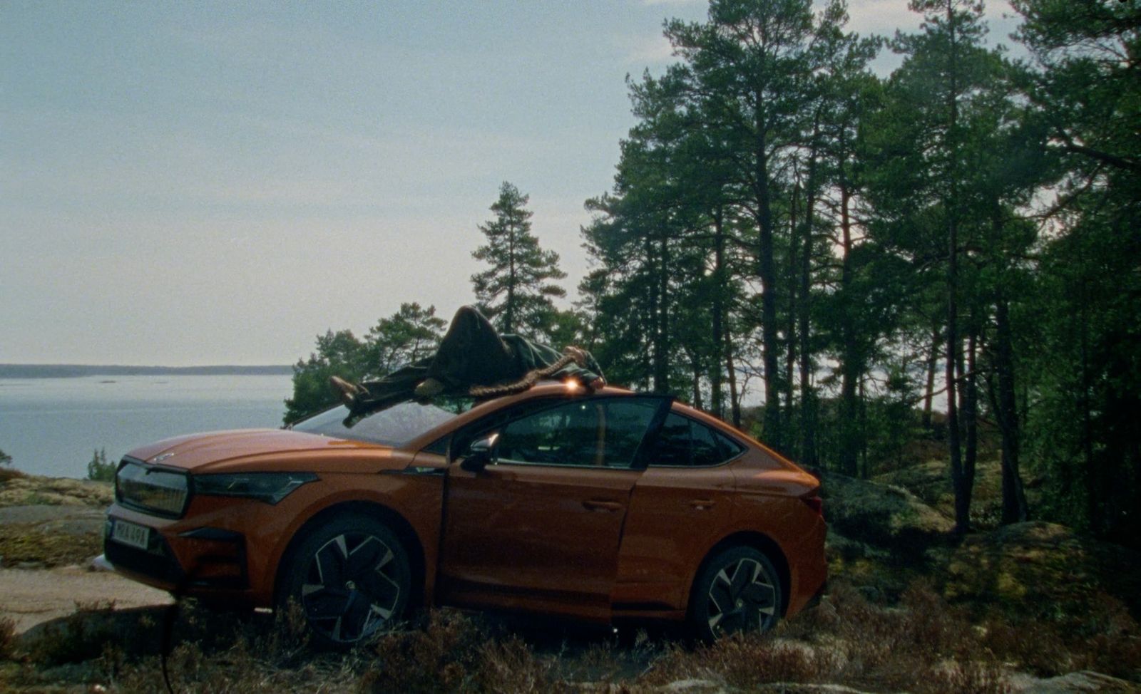 an orange car parked on the side of a road