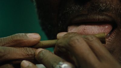 a close up of a person smoking a cigarette