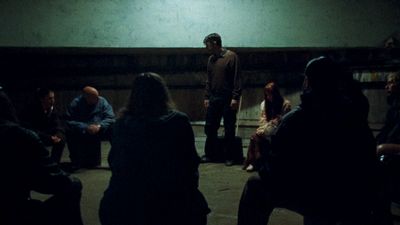 a group of people sitting in a dark room