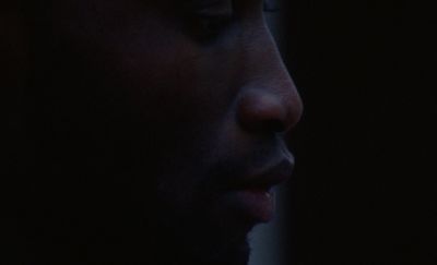 a close up of a man's face in the dark