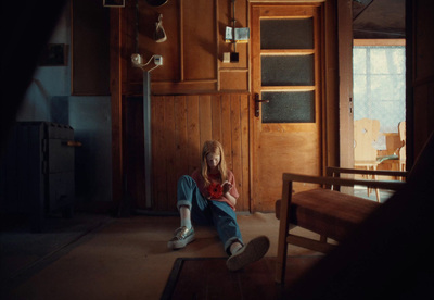 a young girl sitting on the floor in a room