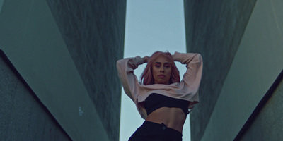 a woman standing in a tunnel with her hands on her head