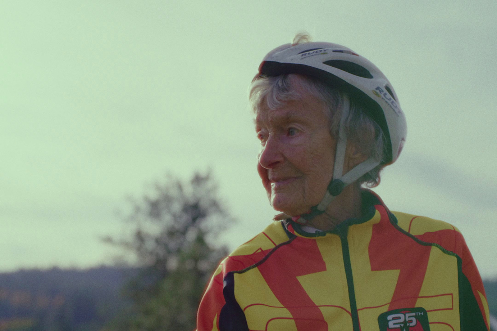 an older woman wearing a bicycle helmet