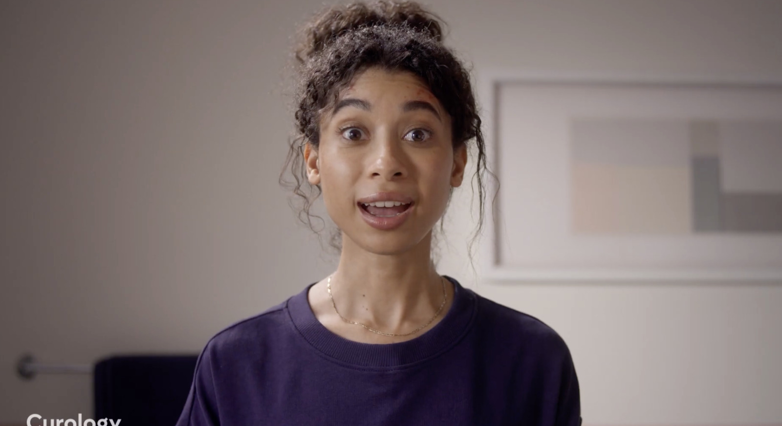 a woman making a funny face while standing in a room