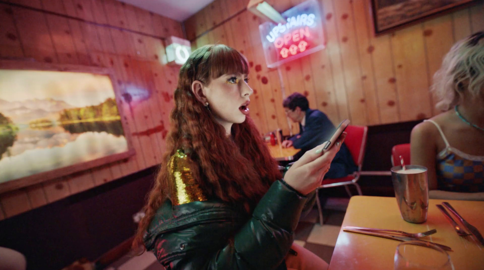 two women sitting at a table in a diner