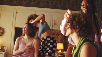 a group of women are standing in a room together