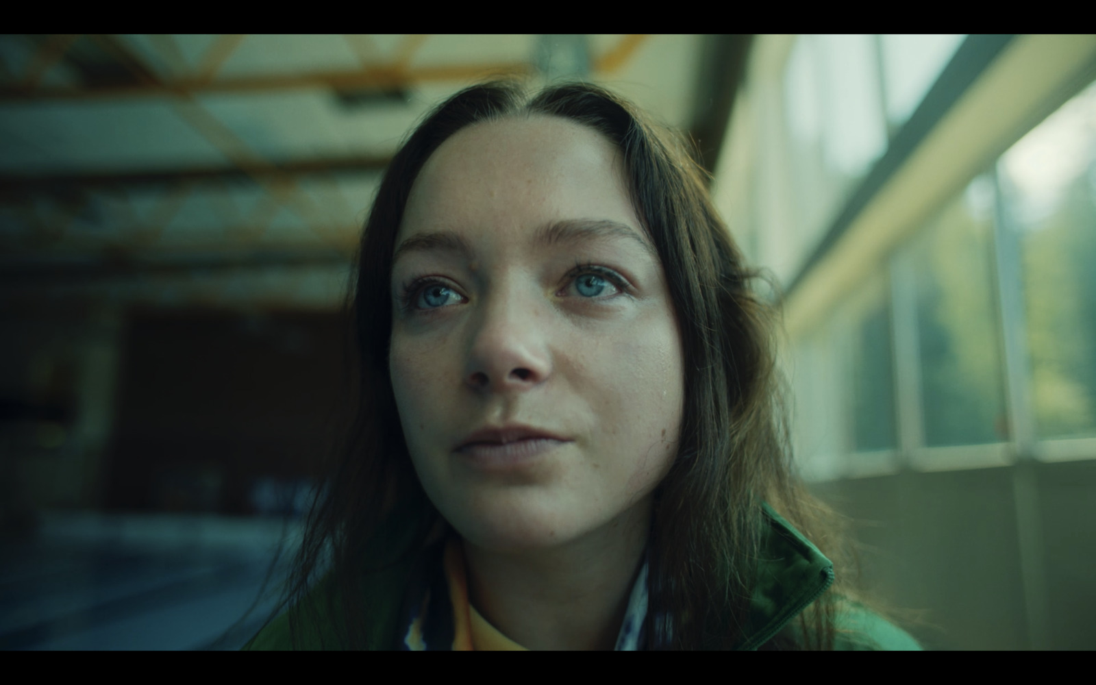  a close up of a person wearing a green jacket