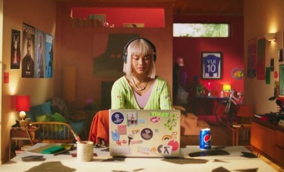 a woman sitting in front of a laptop computer