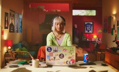 a woman sitting in front of a laptop computer