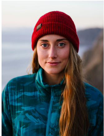  a woman with long hair wearing a red hat