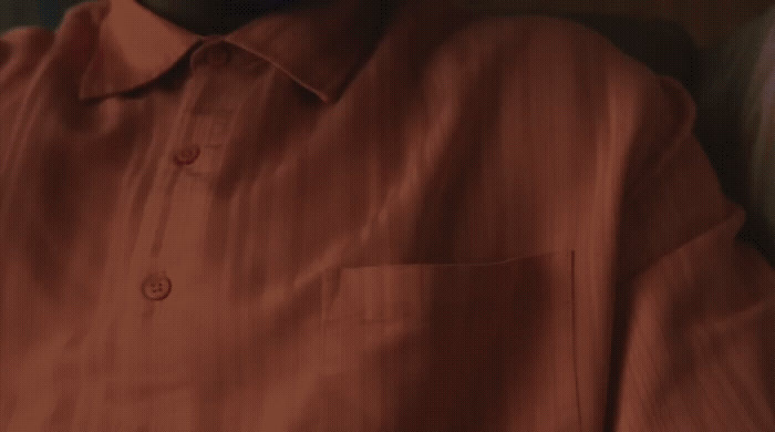 a close up of a person wearing a red shirt