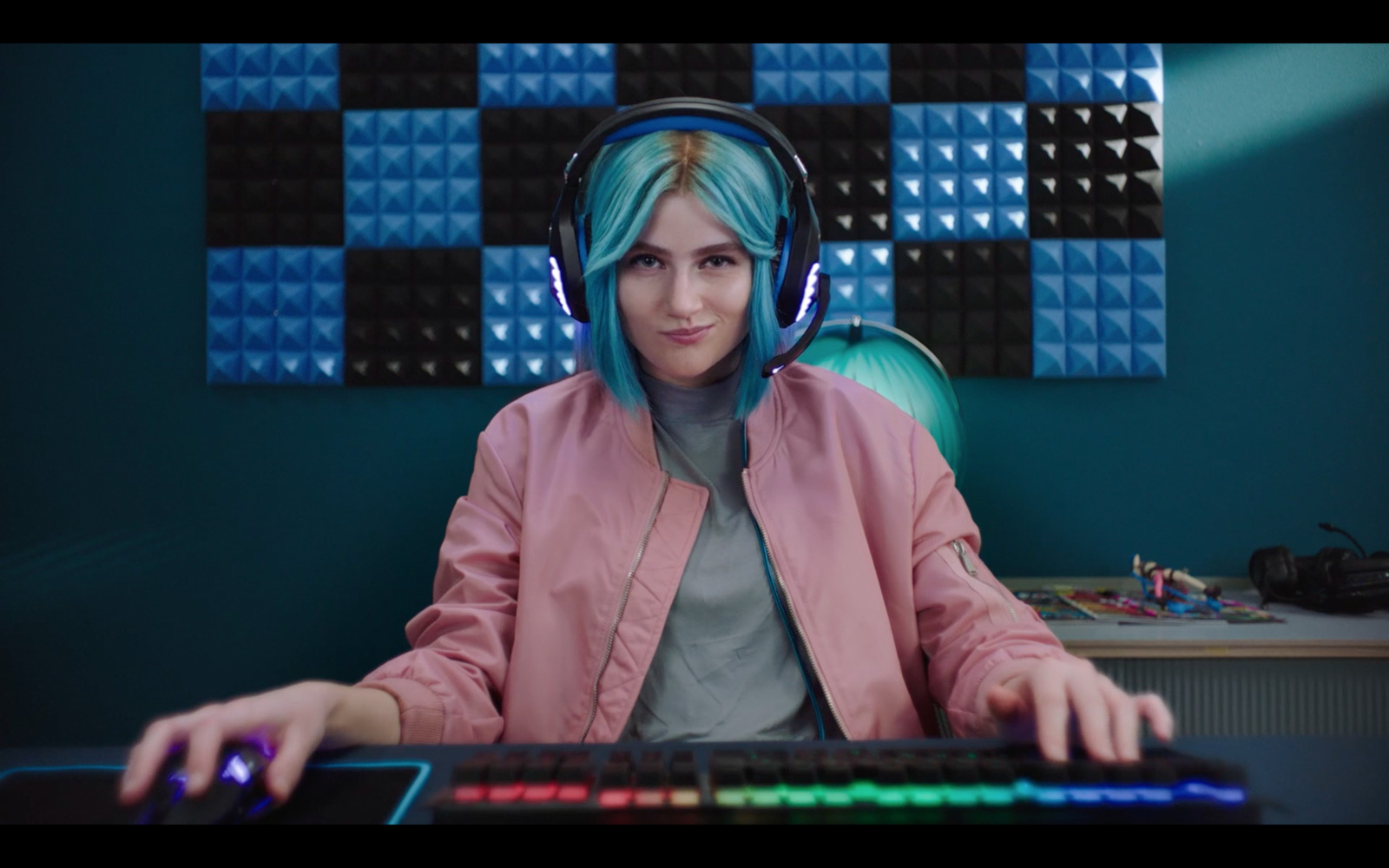 a woman wearing headphones sitting in front of a keyboard