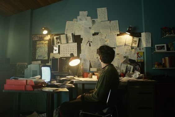 a person sitting at a desk in front of a computer