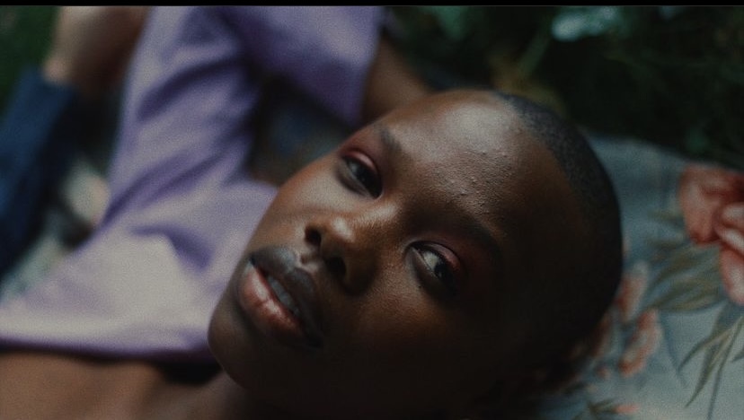 a close up of a child laying on a blanket