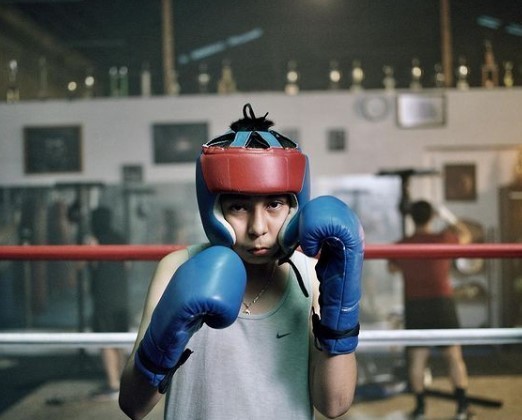 a man wearing boxing gloves and a red helmet