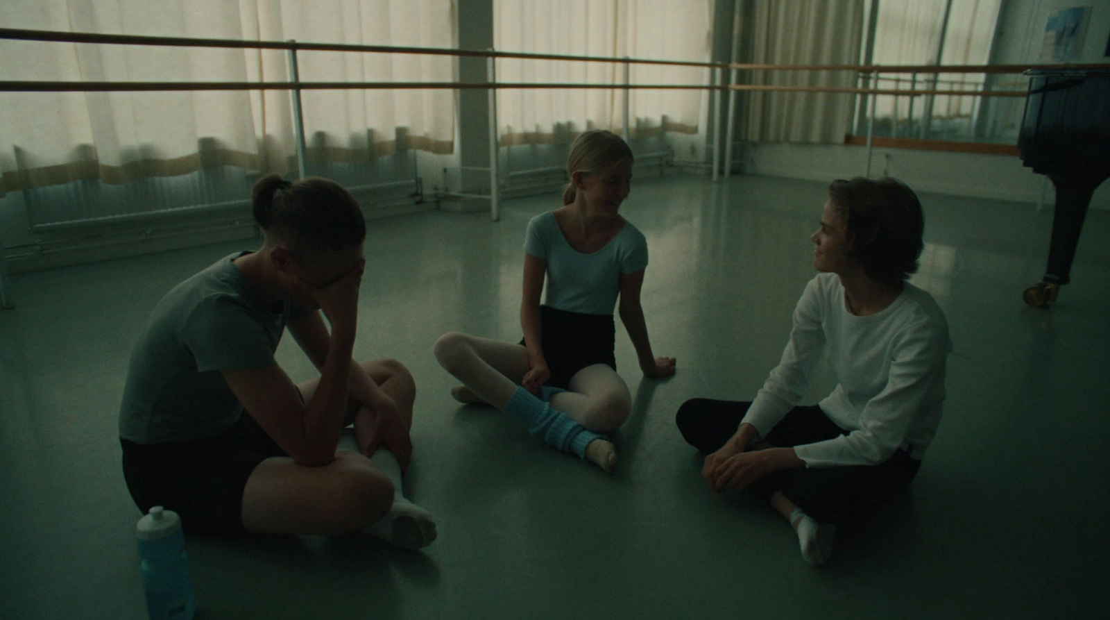 a group of people sitting on the floor in a room