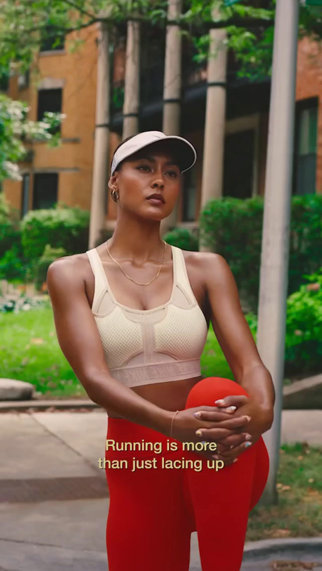 a woman in a sports bra top holding a basketball