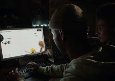 a man and a woman looking at a computer screen