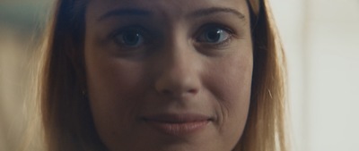 a close up of a woman's face looking at the camera