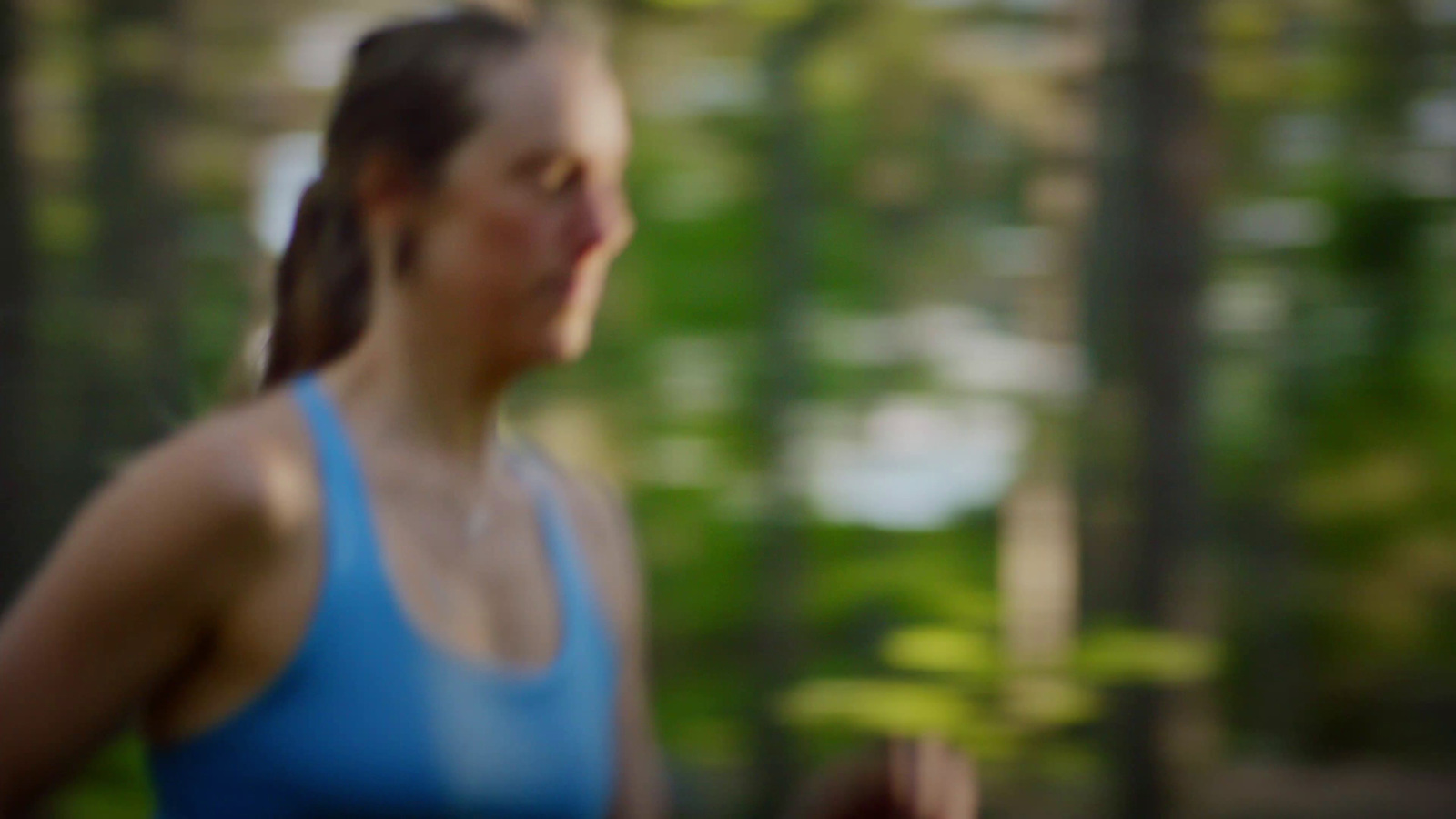 a blurry photo of a woman running in the woods