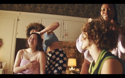 a group of women are getting their hair done in a bathroom