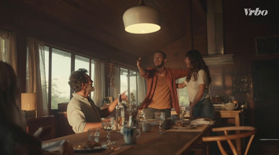 a group of people sitting around a table in a kitchen