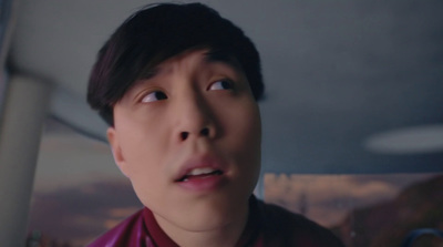 an asian man with a surprised look on his face