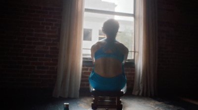 a woman sitting in a chair in front of a window